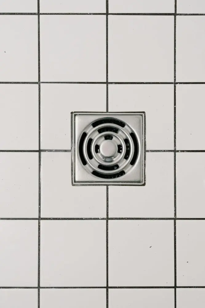 Stainless steel cover of drain in modern shower